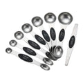 Set of stainless steel measuring spoons with black measurement markings on a light gray background