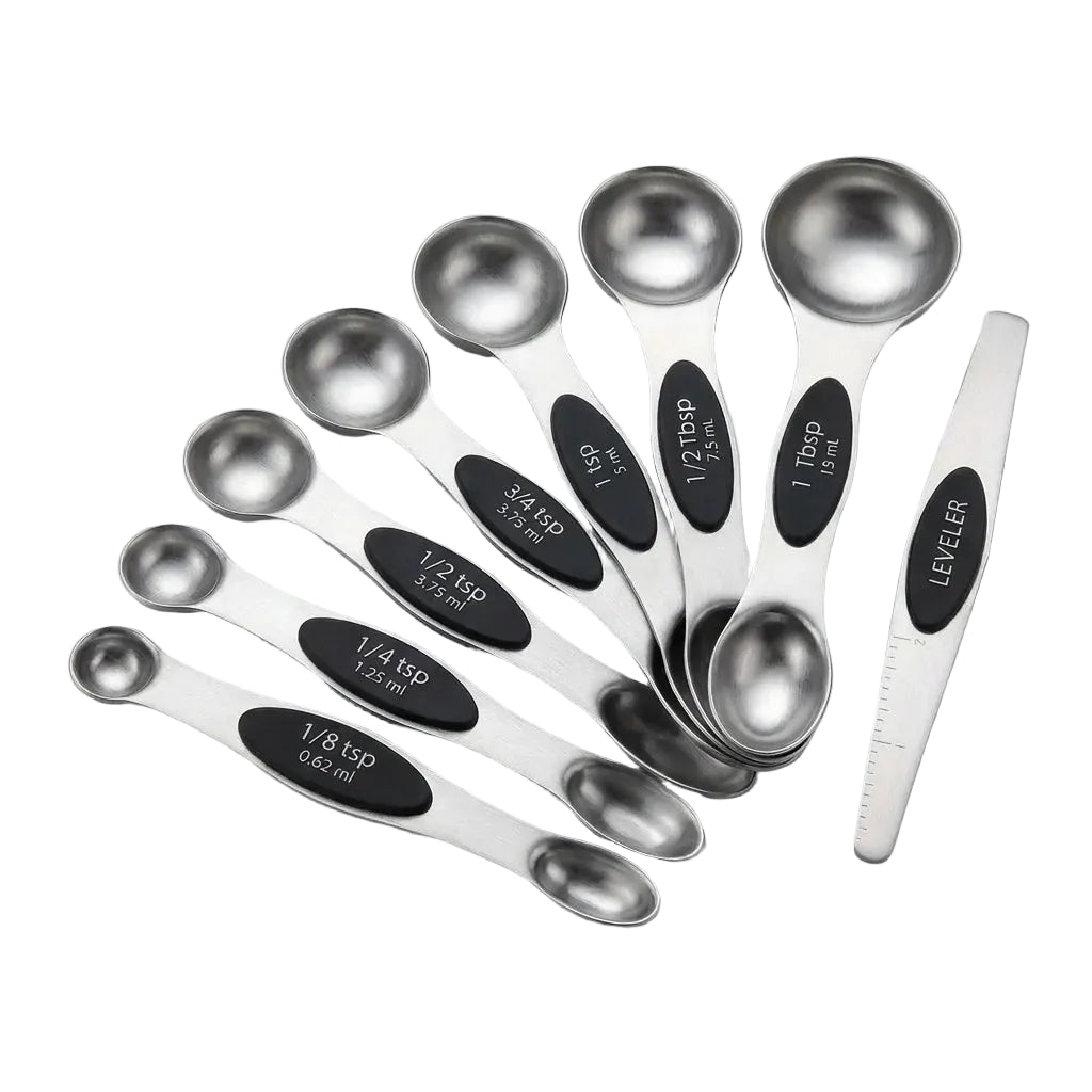 Set of stainless steel measuring spoons with black measurement markings on a light gray background