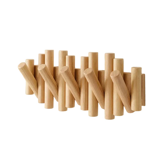 Wooden wall hook with cylindrical protrusions on a beige background